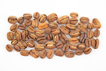 Naklejka premium High-resolution image of roasted coffee beans, highlighting their warm brown shades and natural fissures on a white background. Suitable for caffeine visuals.
