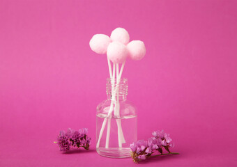 Air freshener on pink. White aroma diffuser bottle with sticks. Minimalism. Top view