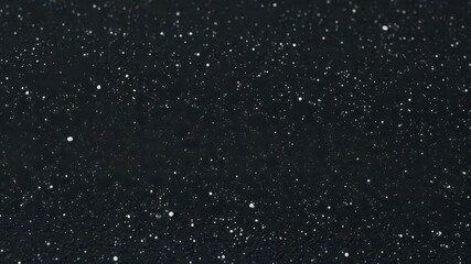 Dark, gritty surface; fine white dust motes, granular texture, rock, floor, black