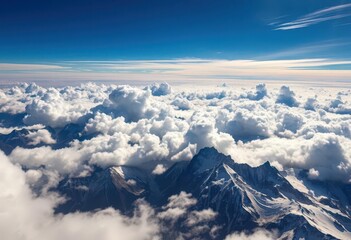 Naklejka premium High altitude cloudscape, sunlit peaks, deep shadows, mountain landscape, panorama