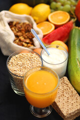 Various healthy fruits, vegetables and cereals on dark background. Selective focus.