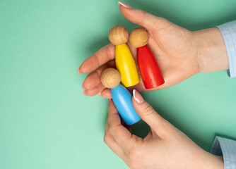 The women chooses a candidate from three figures of people. Hiring. The best candidate for the position. Consideration of skills, experience, and cultural fit.