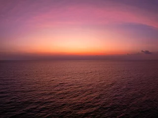 Fotobehang Fluor Roze Colorful sunset or sunrise sky clouds over sea, Amazing nature landscape seascape,Beautiful light nature landscape colorful sky background,High angle view drone shot  © Panya