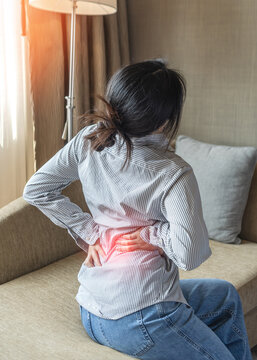 Back pain, lower back ache, muscle ligament strain or spine injury in young adult woman with chronic backache, muscle tightness, stiffness from office syndrome