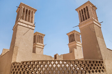 View of 4 traditional air-cooling towers in old city of Yazd, Iran. These towers are called...
