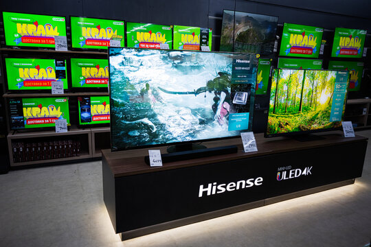 Modern television showroom displaying various models including Hisense ULED 4K screens