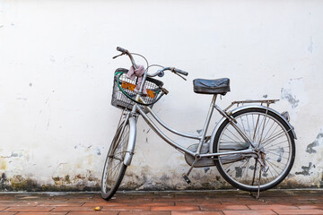 Old bicycle parked against the wall