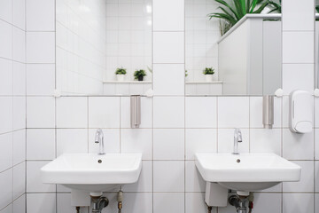 White colour ceramic tiles toilet hand wash area. White colour theme toilet interior. Cleanliness...