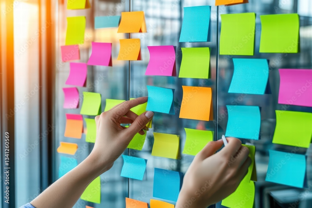 Poster professional hands placing sticky notes on glass wall for collaborative brainstorming and idea organ