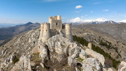 Aerial view of the castle of Rocca Calascio. It is a fortress located in the municipality of Calascio, in Abruzzo, Italy. In the background is the Gran Sasso mountain range with snow-capped peaks. © Stefano Tammaro