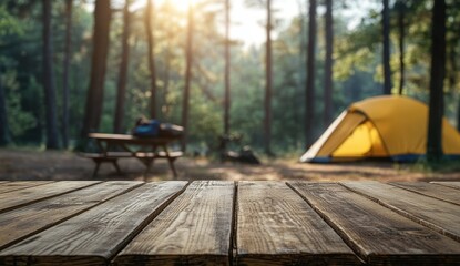 Sunlit campsite with yellow tent and wooden table in forest setting.
