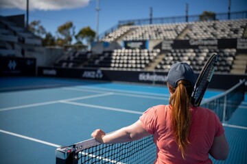 female Professional athlete Tennis player playing on a court in a tennis tournament in summer in...