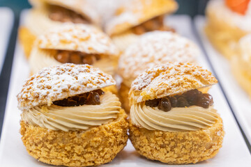 A cream puff is a classic pastry made from light and airy choux dough, baked to a golden brown perfection. The delicate, hollow shell is filled with a luscious, smooth cream—often custard