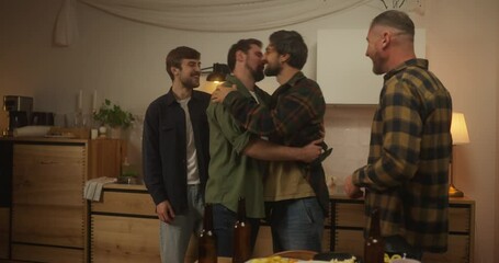 Four happy guys greeting each other and shaking hands during the start of a bachelor party at home in the evening