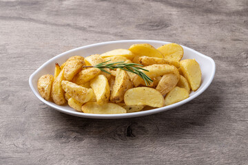 Rustic baked potatoes in a plate over wooden table