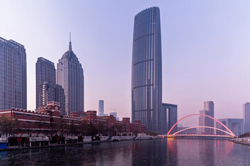 Fototapeta premium sunset waterfront downtown skyline with Tianjin high-rise building cityscape at Haihe riverside, , Tianjin city, China