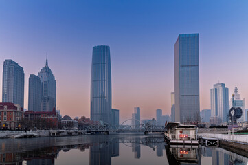 Naklejka premium sunset waterfront downtown skyline with Tianjin high-rise building cityscape at Haihe riverside, , Tianjin city, China