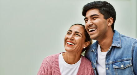 Obraz premium Smiling hispanic mother and son bonding joyfully together
