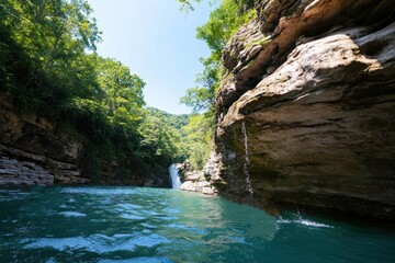 An idyllic scene featuring a striking waterfall cascading into a tranquil pool, framed by an abundance of lush greenery, demonstrating nature's powerful beauty.