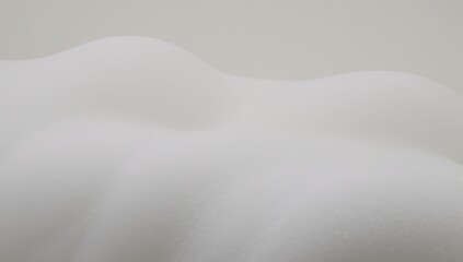 Fototapeta premium An abstract image featuring a white soap-like foam texture filled with swirling bubbles to represent shampoo foam