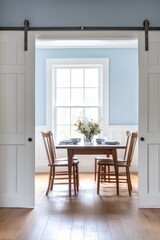A dining room with table chairs and flowers inside