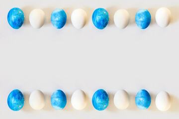Easter frame with blue and white color eggs isolated on gray background. Stylish trendy minimal set or composition with natural painted egg. Flat lay, top view, place for text. Happy egg hunt concept