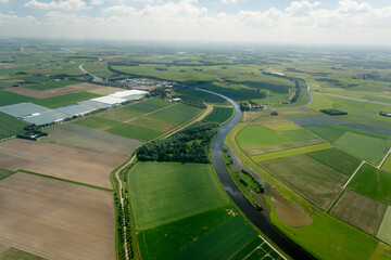 Stunning aerial view of Buitengebied's lush green fields and winding rivers captured during a clear...