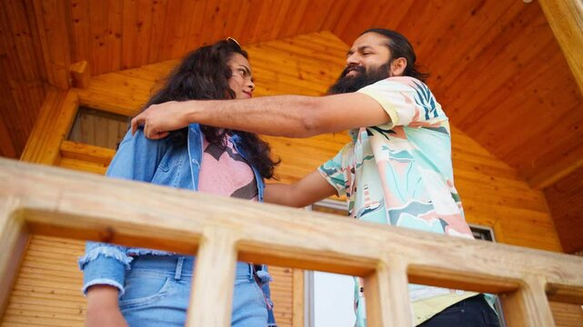 Couple in love embraces on wooden porch outdoors
