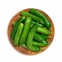 top view flat lay pile of Dutch holland green cucumber isolated on white background in wood plate