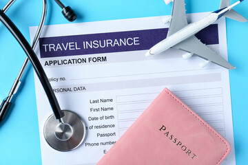 Medical tourism. Travel insurance application form, stethoscope, passport and plane model on light blue background, flat lay