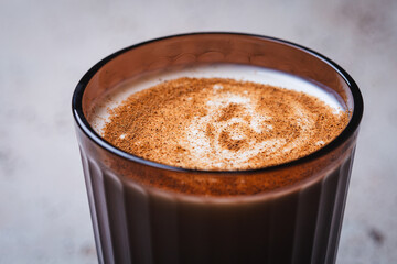 Kefir with cinnamon in brown glass. Drink for health and detox.