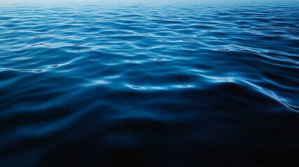 Fototapeta premium Subtle rippling water patterns across a serene navy-to-sky-blue gradient, evoking calm and depth