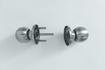 Silver metal disassembled door handle on white background.