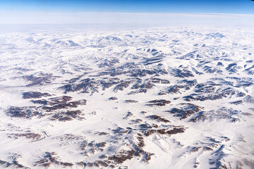 The snow-capped Tangla Mountains of the Tibetan Plateau in China, a high-altitude view from an airplane