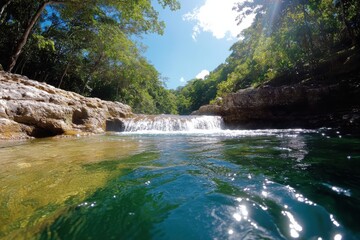 Fototapeta premium Breathtaking river waterfall cascades over smooth rocks creating a picturesque scene of tranquility and natural harmony, embodying the essence of earth's pristine beauty.