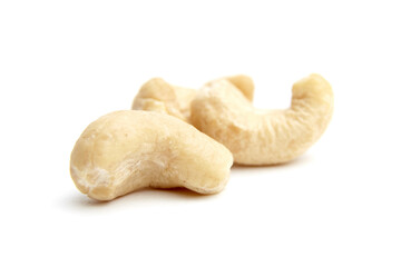 Close-up of whole raw cashew nuts with a creamy, curved shape. Isolated on a white background, perfect for healthy food and snack concepts
