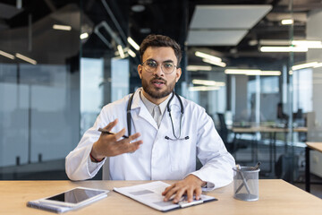 Webcam view, doctor consults patients remotely. Man in white medical coat, uses video call, for...