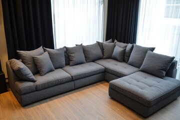 A comfortable gray sectional sofa placed near window curtains