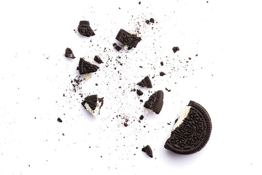 Delicious Oreo biscuits with chocolate and cream on white background	