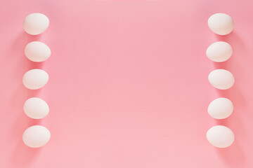 Frame of Easter white natural eggs set isolated on pastel pink background. Stylish trendy composition with chicken egg. Flat lay, top view, place for text. Happy eco-friendly holiday, minimal concept