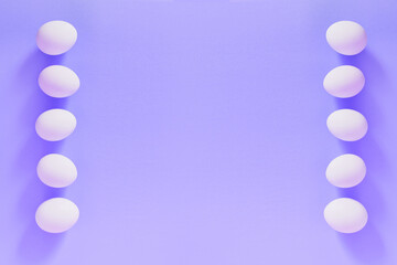 Frame of Easter white natural eggs set isolated on pastel violet very peri background. Stylish trendy composition with egg. Flat lay, top view, place for text. Eco-friendly holiday, minimal concept