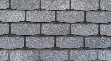 Gray bitumen shingles in the shape of flakes background