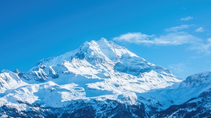 Obraz premium A snow-covered mountain peak under a clear blue sky.