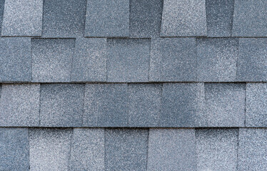 Gray bitumen shingles with a grainy texture