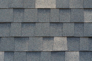 Close-up texture of dark gray asphalt roofing shingles