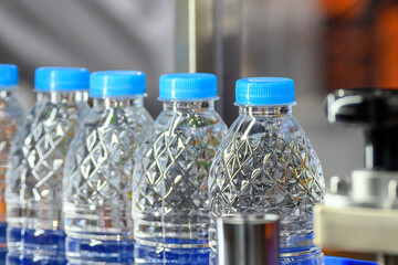 The  full filled drinking water bottles  on the conveyor belt.