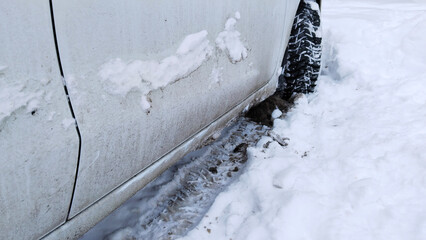 Dirty dusty car. messy snow. Mud, salt and chemicals on winter road. Ecology in city. Protection and wash auto. Driving. Vehicle hubcap. Tire pressure. Tyre change. Environmental pollution concept.