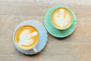 two cups of Latte art in flat angel shot in cafe