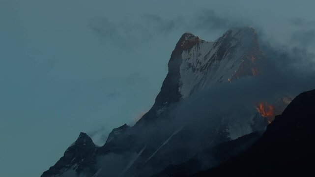 Fishtail mountain or Mt. Machapuchare sunrise timelapse with clouds drifting. Famous himalayan peak in nepal.