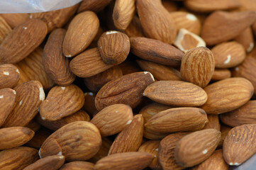 Almonds piled together in a rustic setting, showcasing their natural hues and textures that evoke a sense of wholesome nourishment